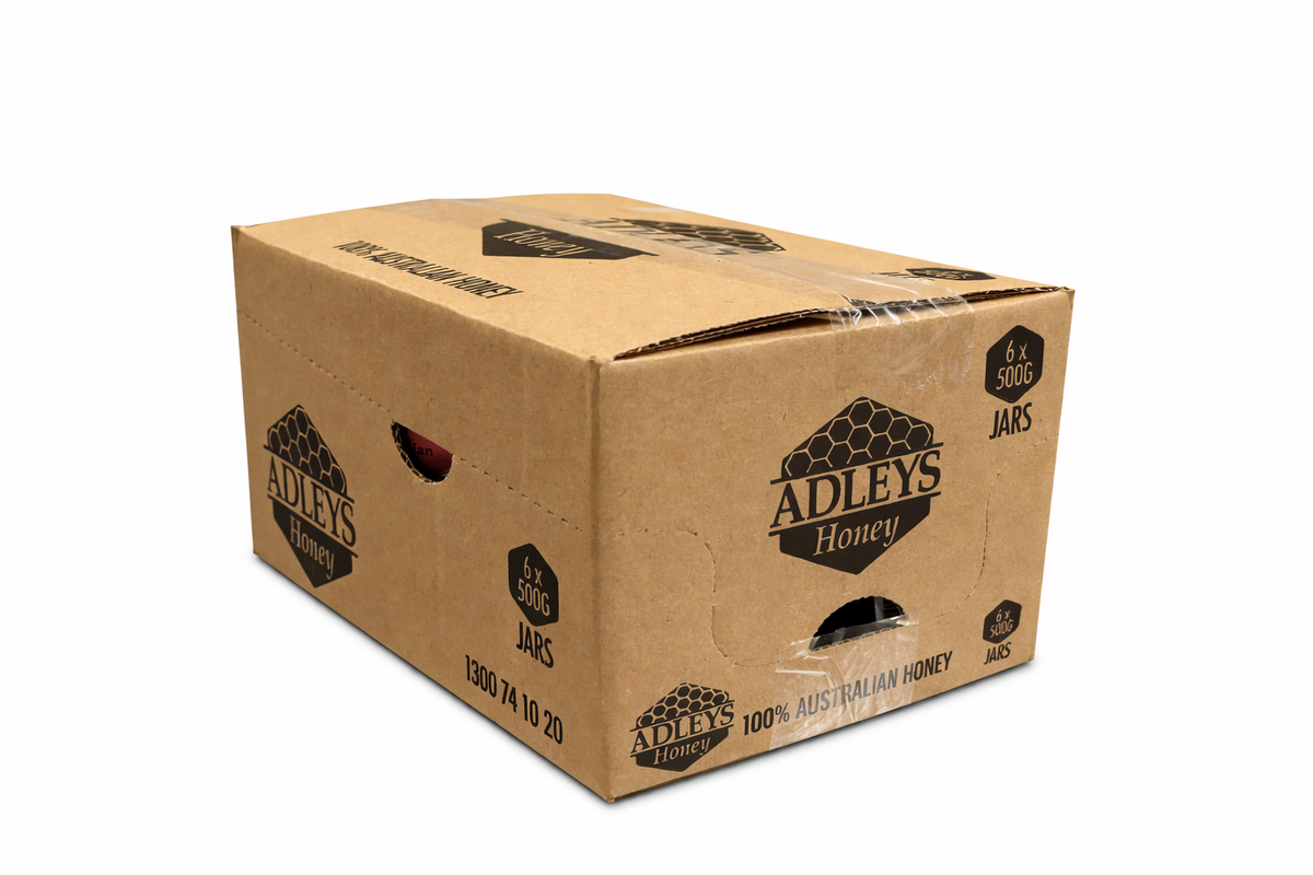 Cardboard box with Adley's Honey branding on a white background