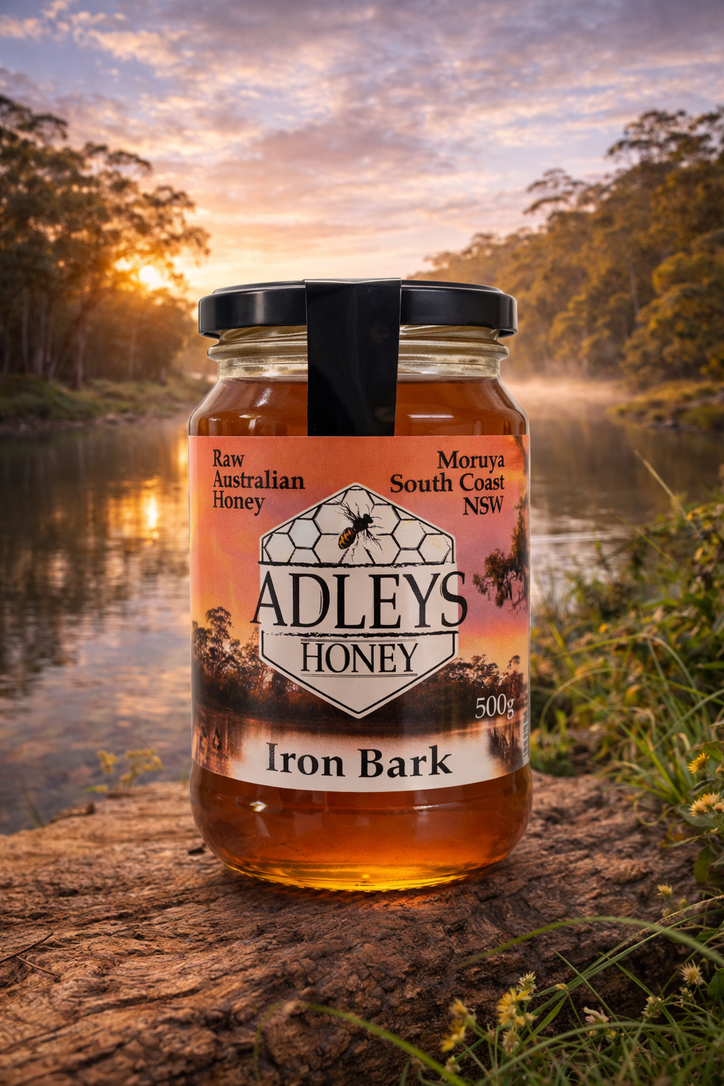 Jar of Adley's Honey with a scenic background of a river and trees.